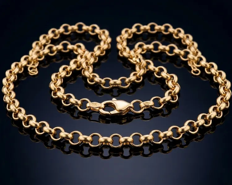 Gold chain on a reflective black surface
