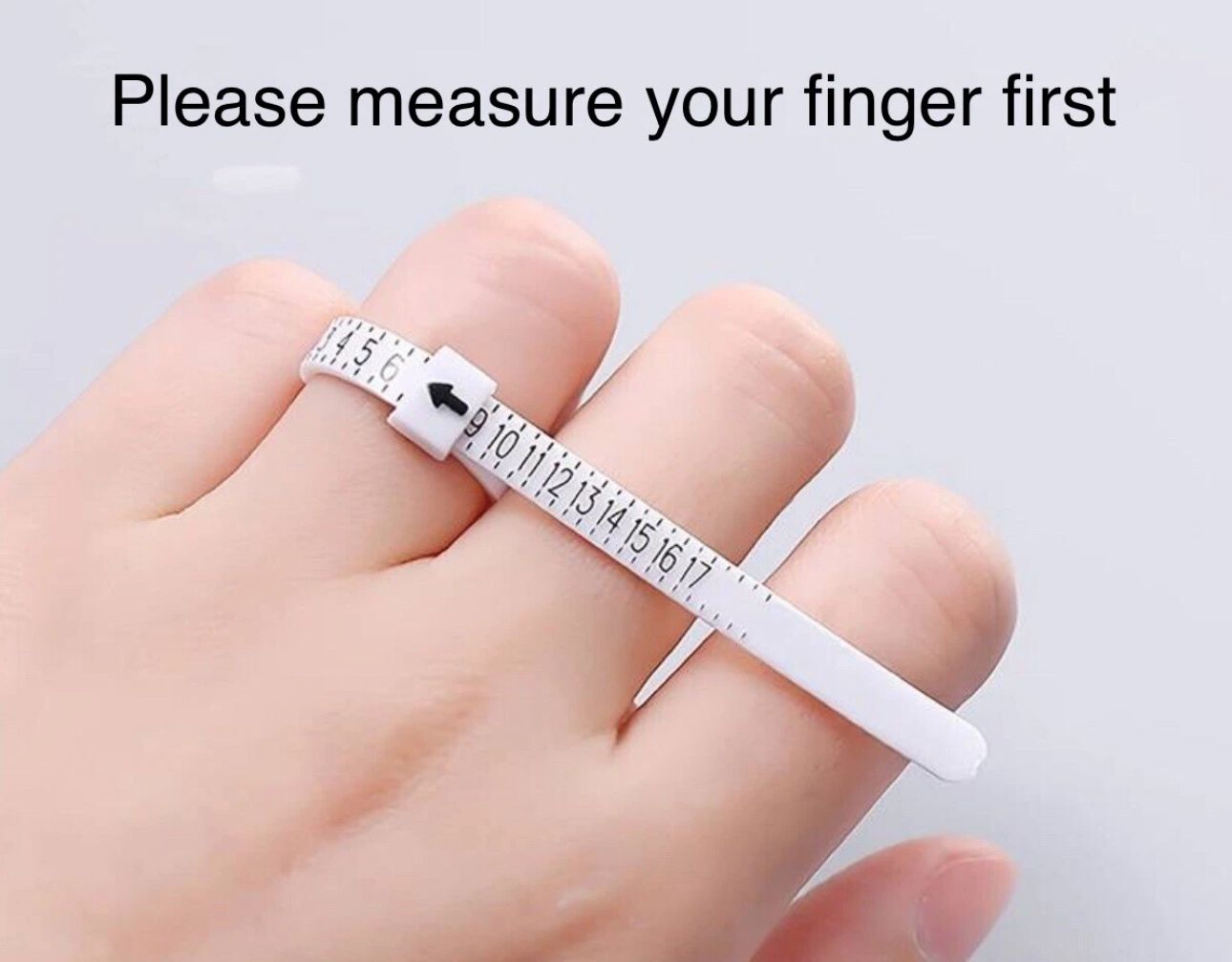 Finger measurement tool on a finger with text 'Please measure your finger first' on a light gray background