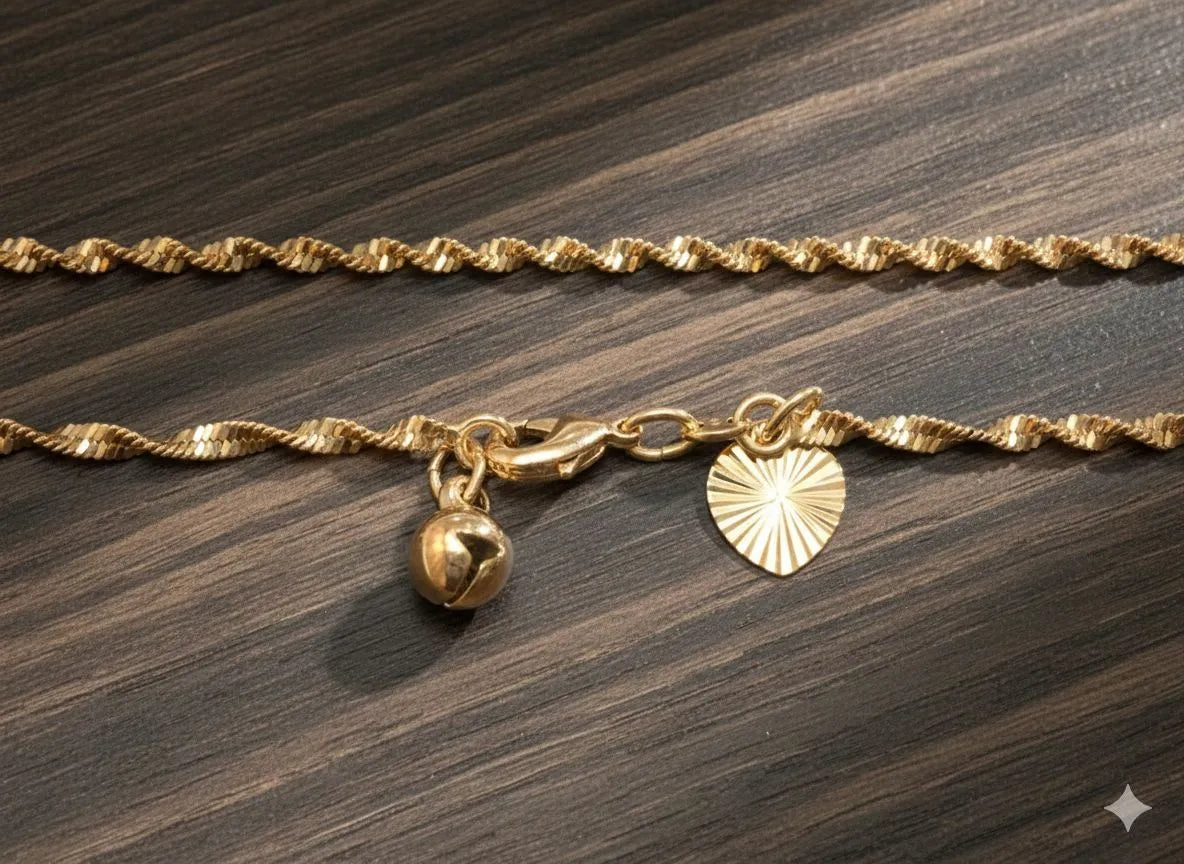 Gold bracelet with charms on a wooden surface