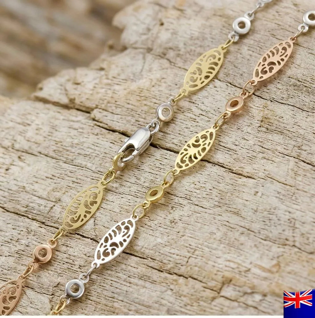 Gold and silver bracelet on a wooden surface with a British flag in the corner