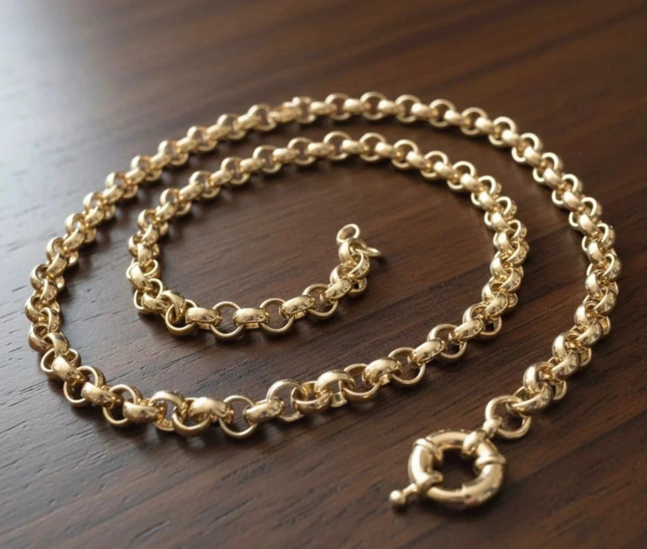 Gold chain necklace on a wooden surface