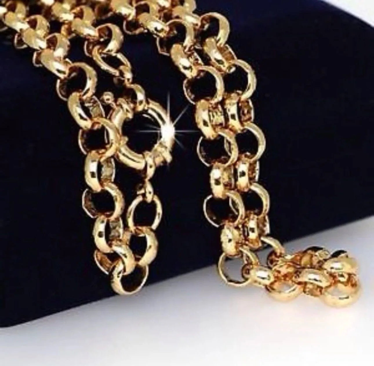 Gold chain necklace on a black and white background