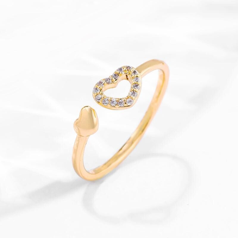 Gold ring with a heart-shaped design on a white background