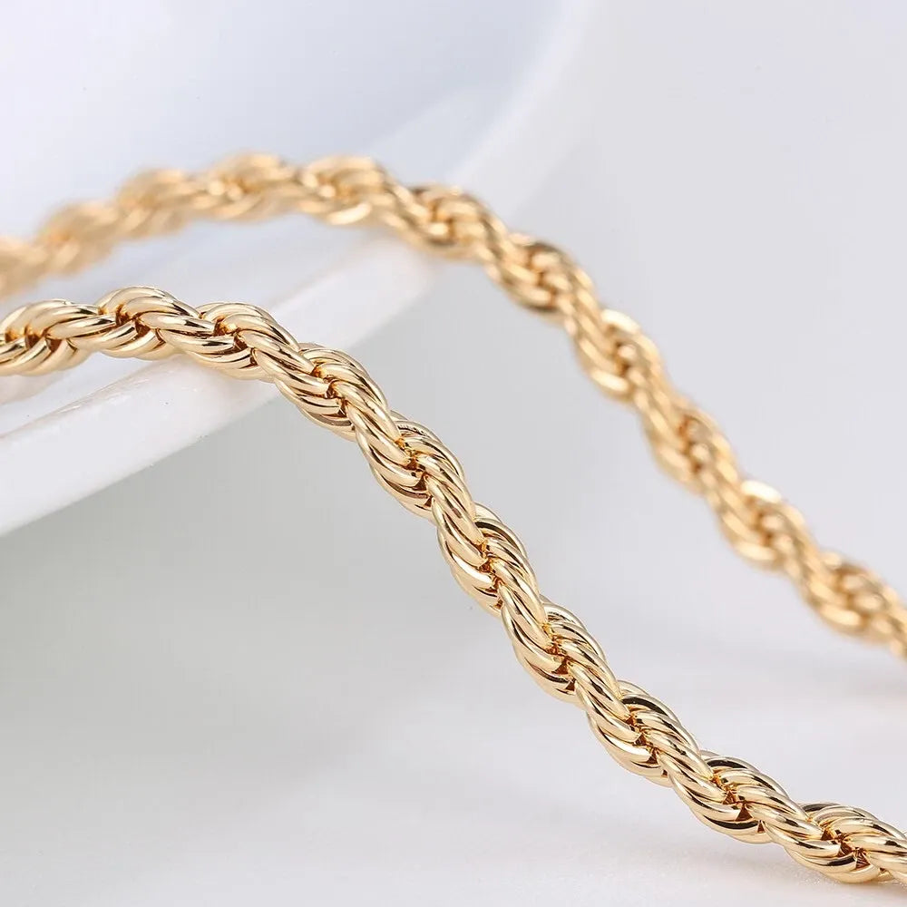 Gold rope chain bracelet on a light gray background