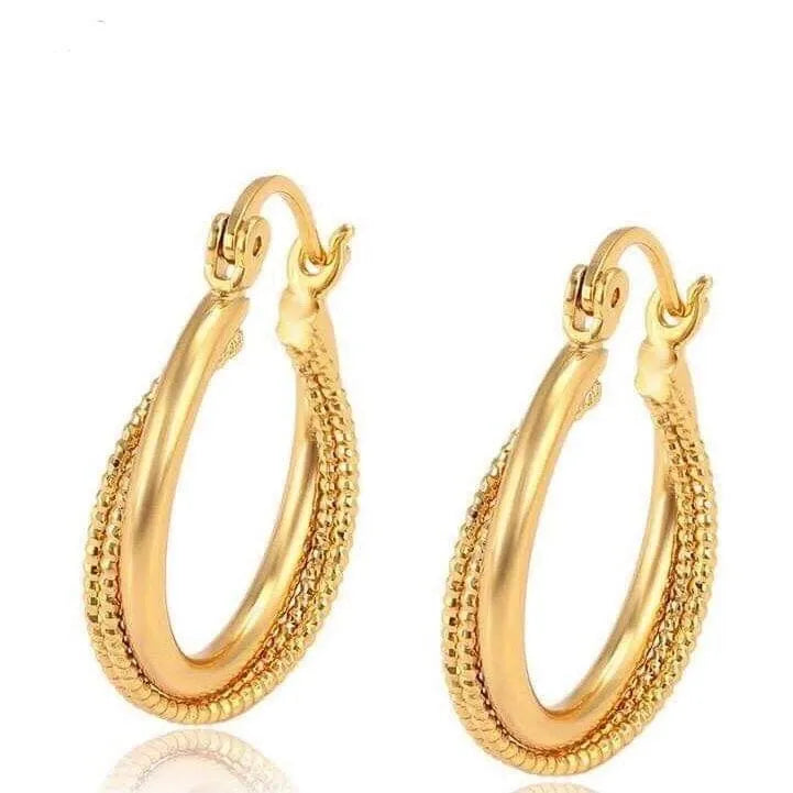 Gold hoop earrings on a white background
