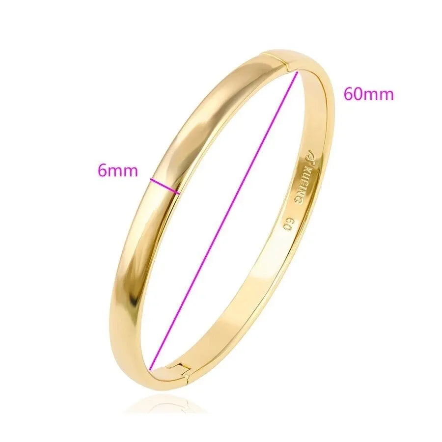 Gold bangle with measurements on a white background