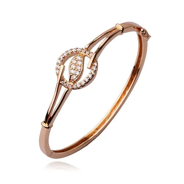 Rose gold bracelet with leaf design on a white background