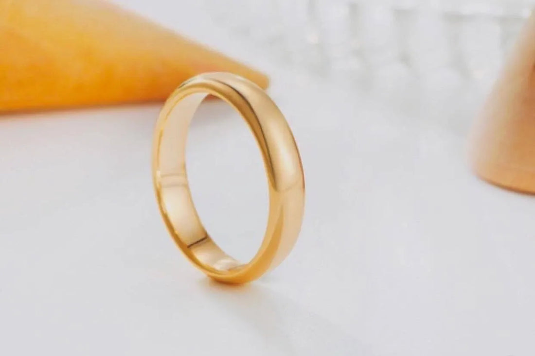 Gold ring on a light gray background