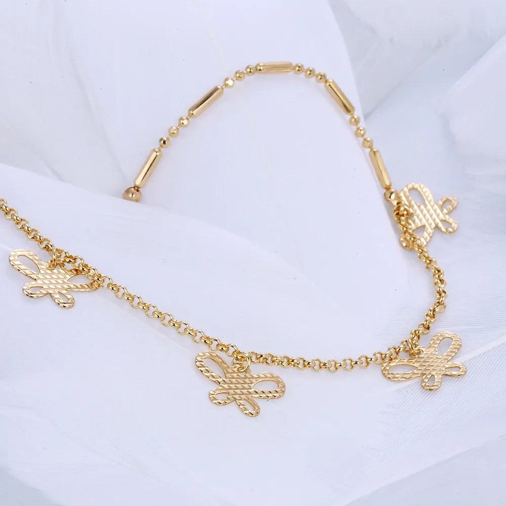 Gold necklace with butterfly charms on a white background