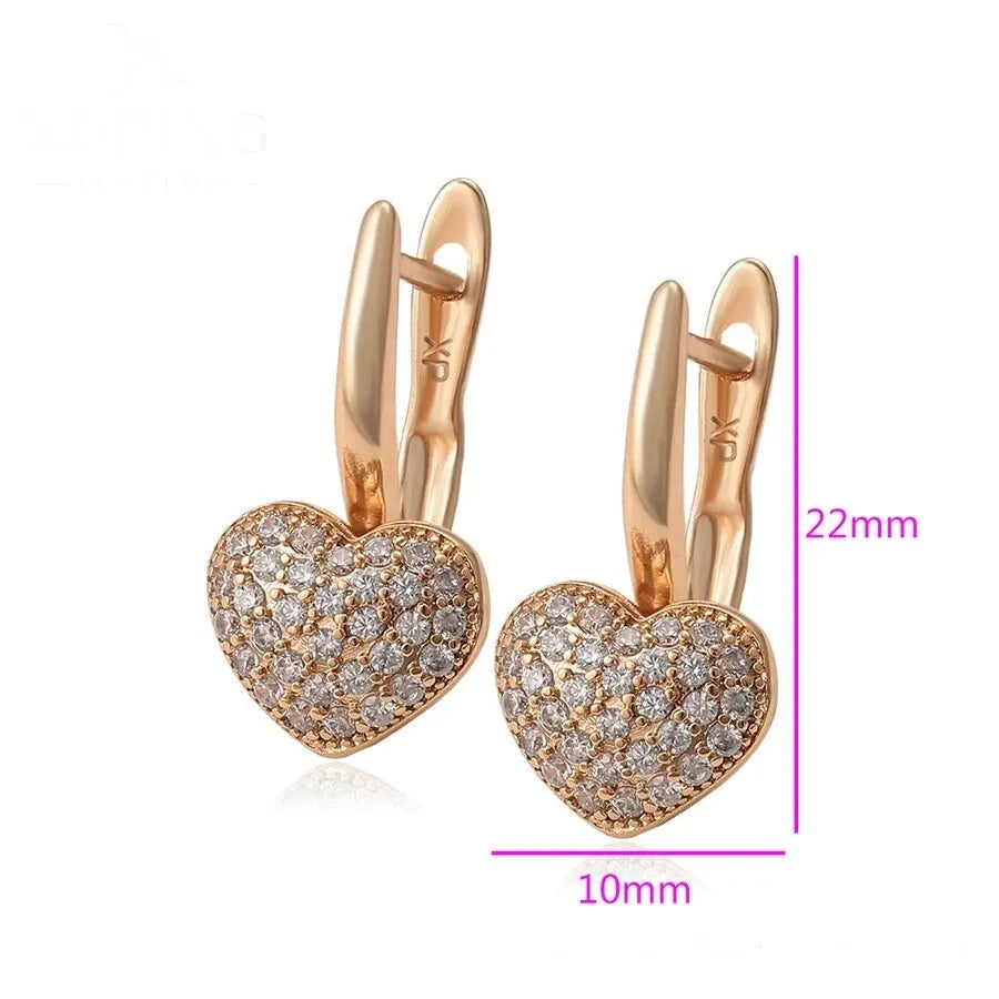 Rose gold heart-shaped earrings with diamond accents and measurements on a white background