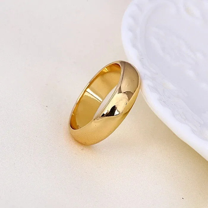 Gold ring on a light beige fabric background