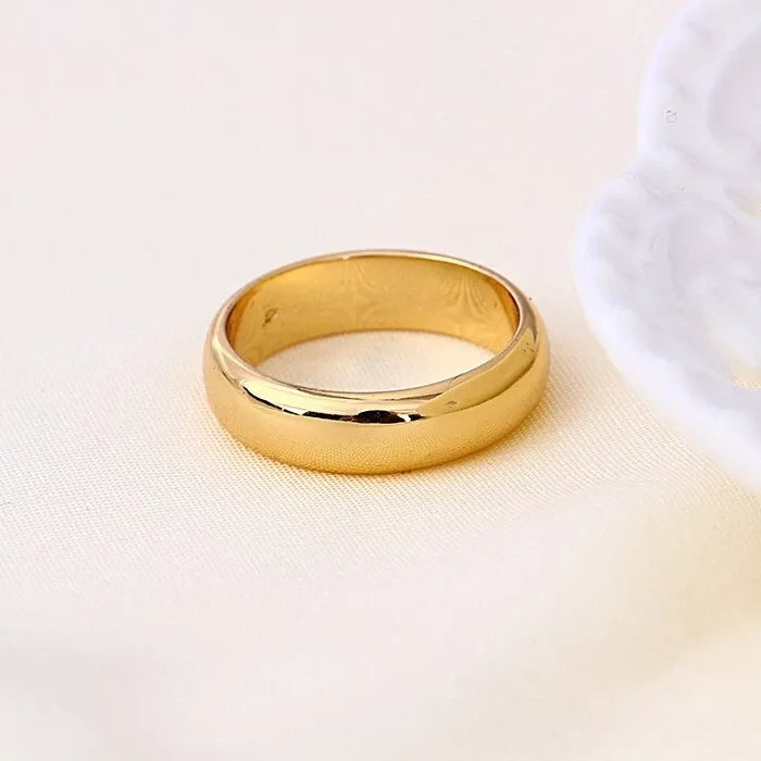 Gold ring on a light beige background