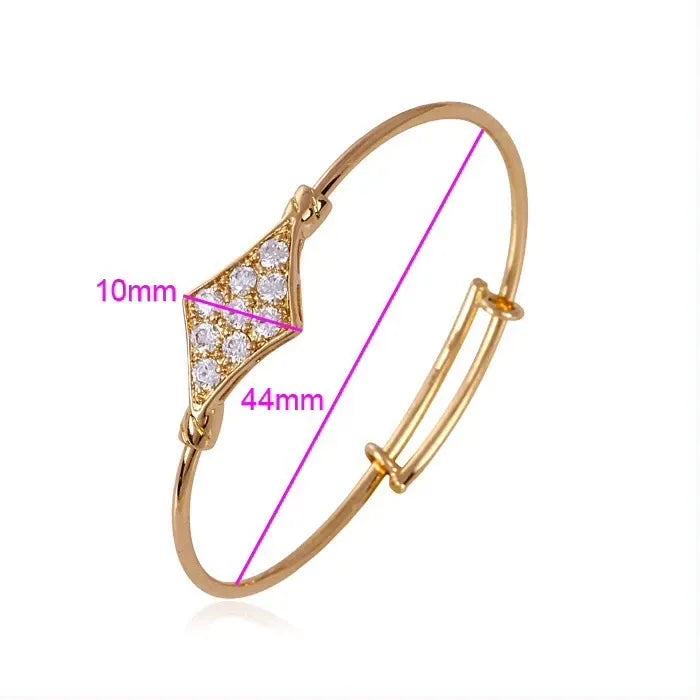 Gold bracelet with diamond accents and measurements on a white background