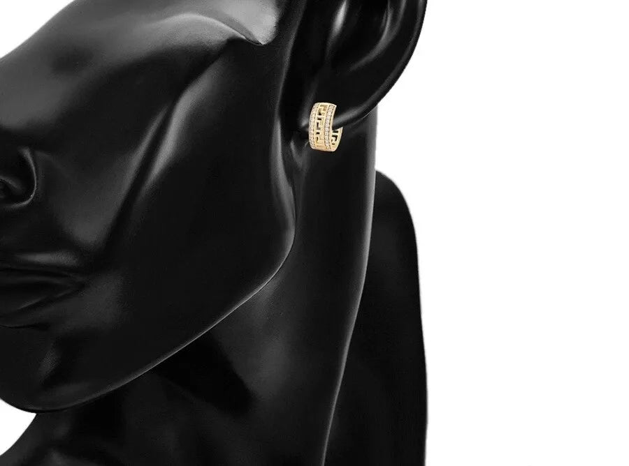 Gold earring on a black satin background