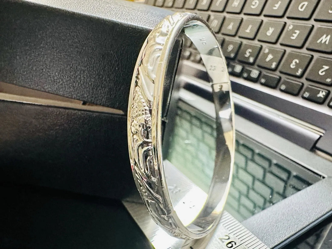 Silver ring with intricate design on a laptop keyboard