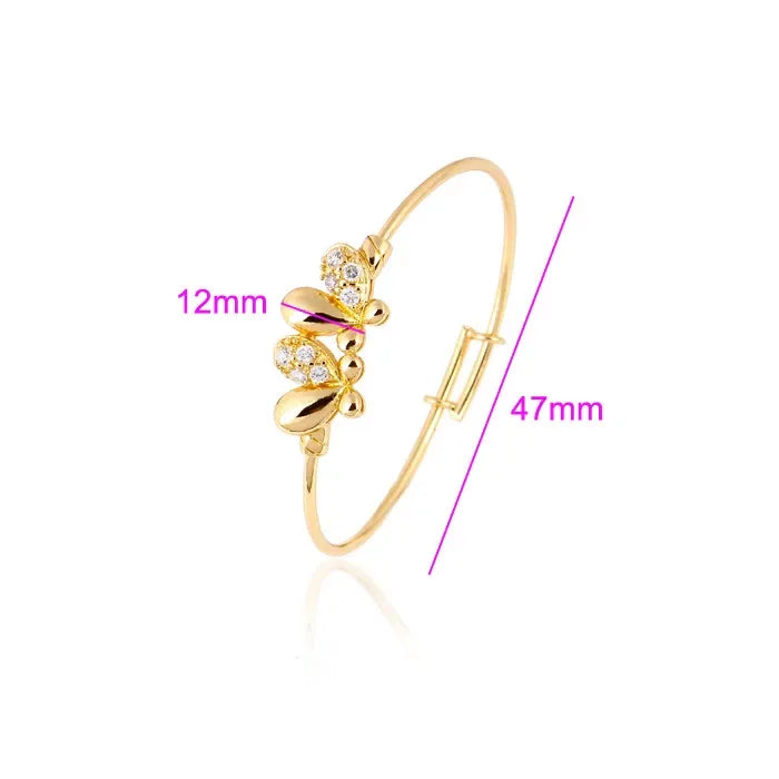 Gold bracelet with measurements on a white background
