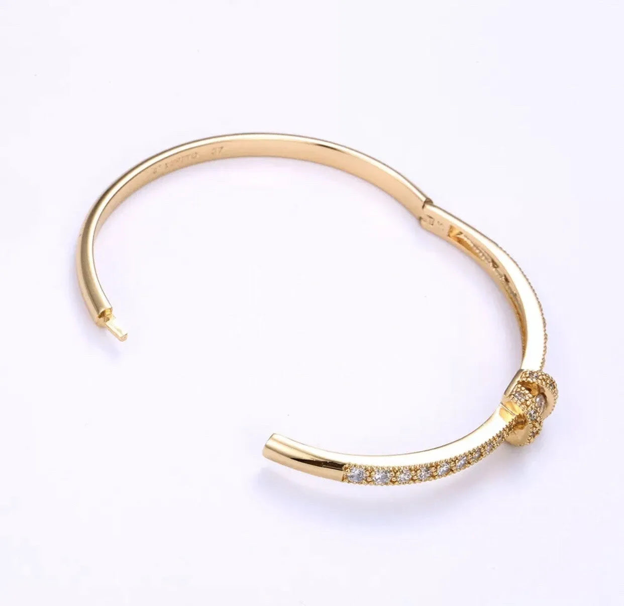 Gold BRACELET with small diamonds on a white background