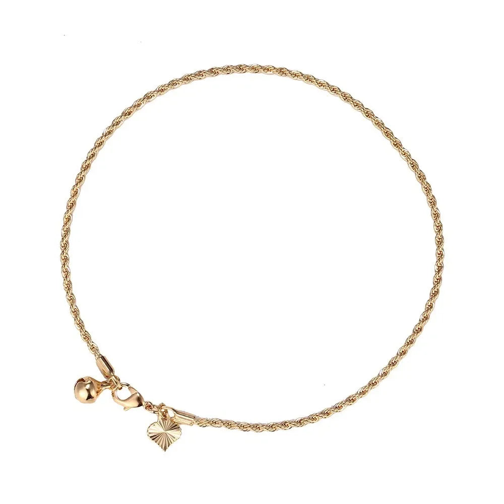 Gold bracelet with two charms on a white background