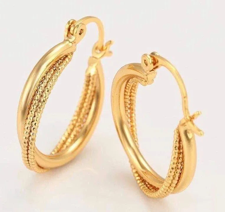 Pair of gold hoop earrings on a light background