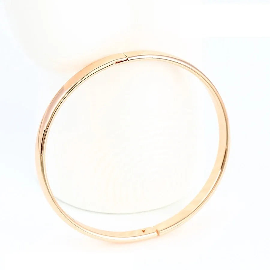 Gold bangle on a white background