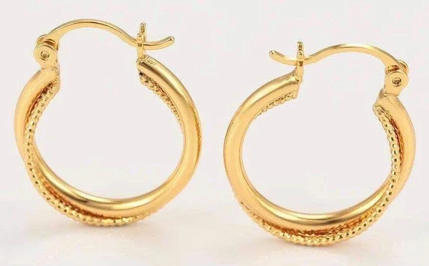 Pair of gold hoop earrings on a light background
