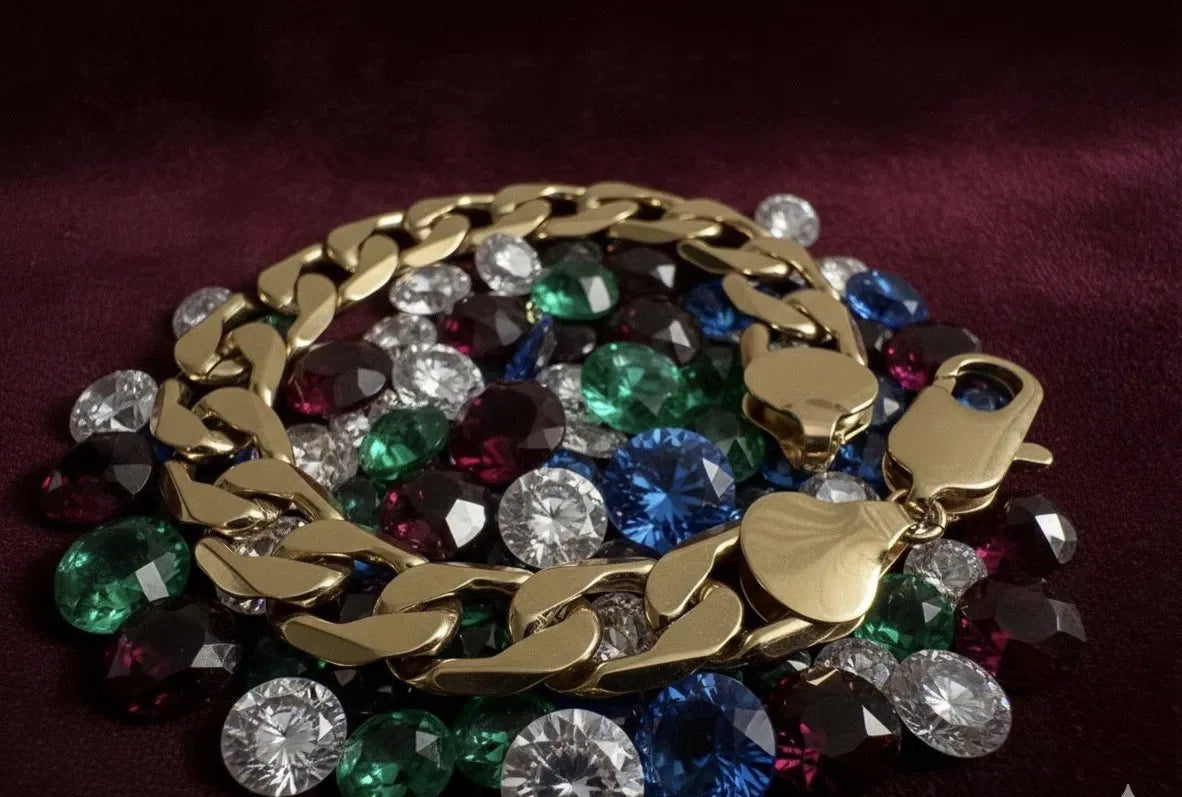 Gold chain bracelet with colorful gemstones on a dark background