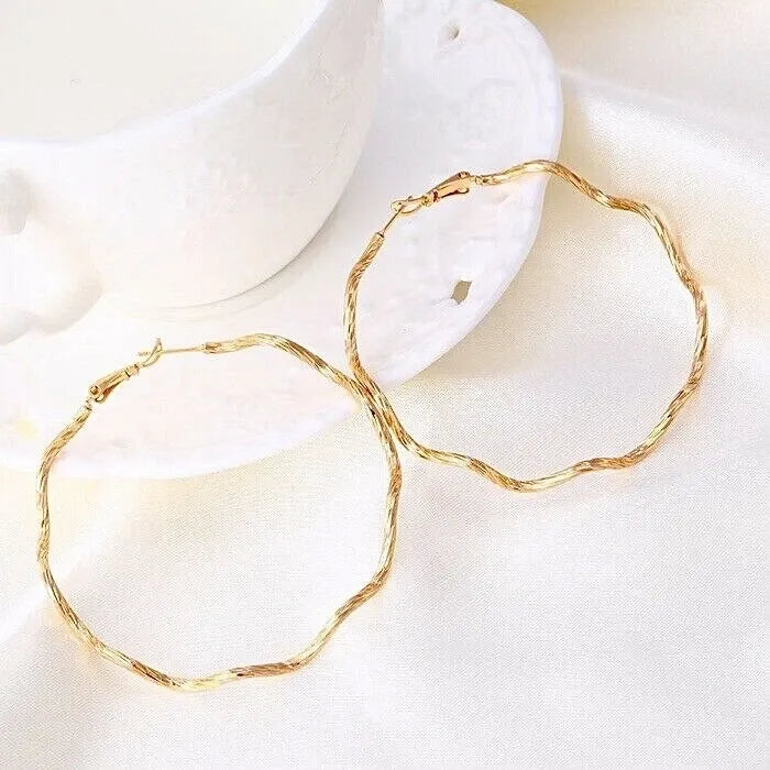 Gold hoop earrings on a white background