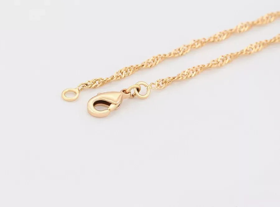 Gold chain Anklets on a light gray background