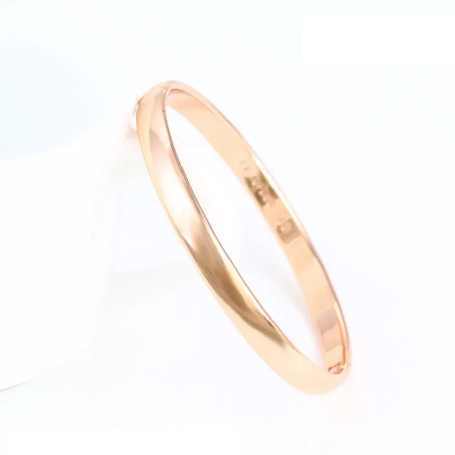 Rose gold bangle on a white background