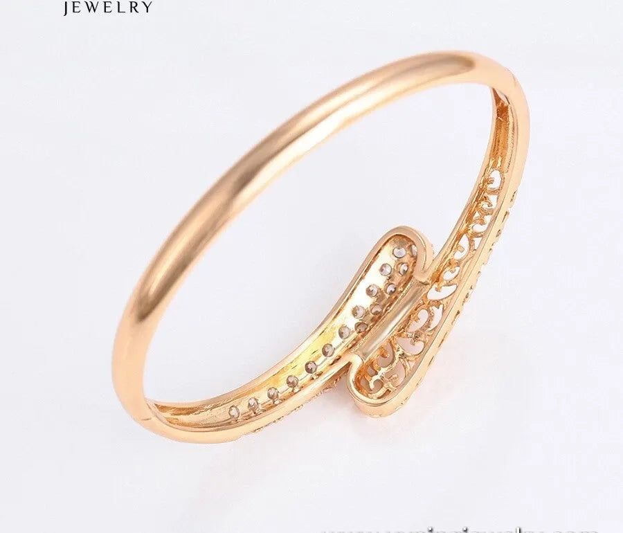 Gold bracelet on a white background with 'JEWELRY' text.