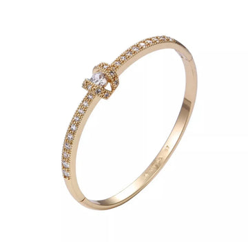 Gold ring with embedded diamonds on a white background