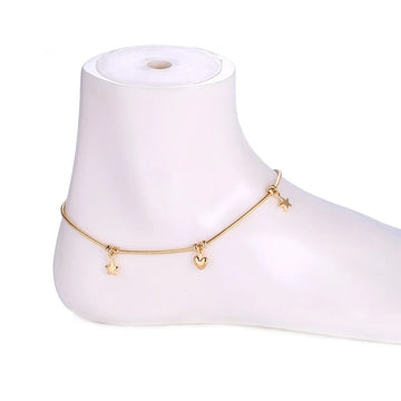 Gold anklet with charms on a white mannequin foot