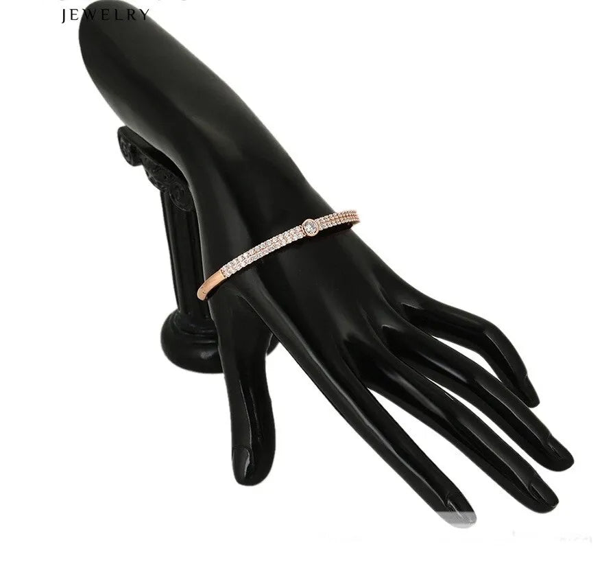 Rose gold bracelet on a black mannequin hand with 'Jewelry' text above.