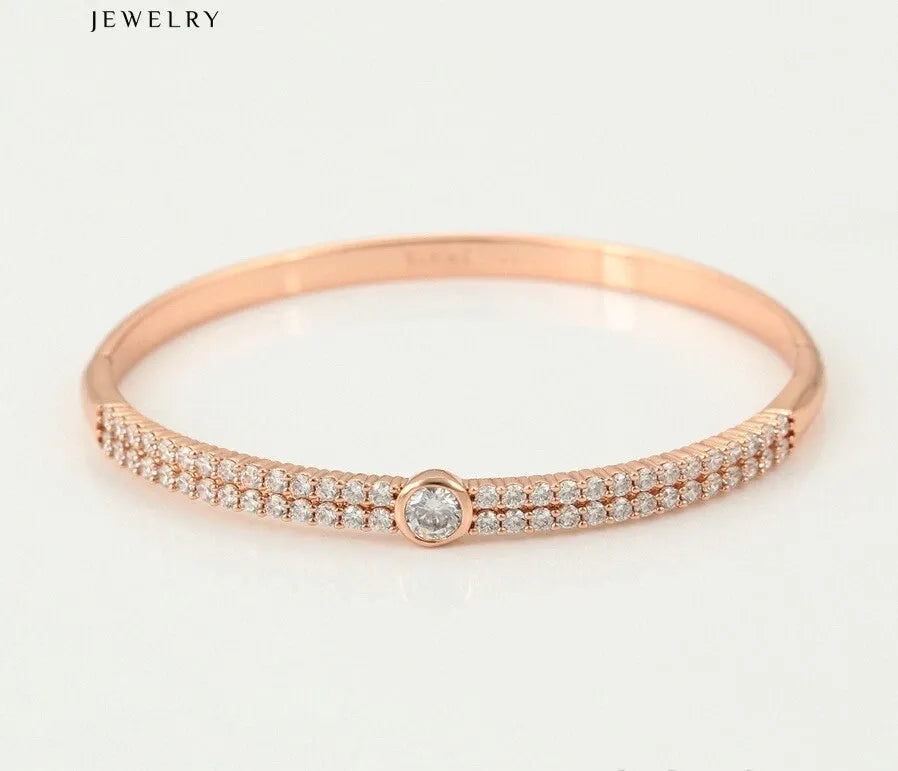 Rose gold bracelet with diamonds on a white background