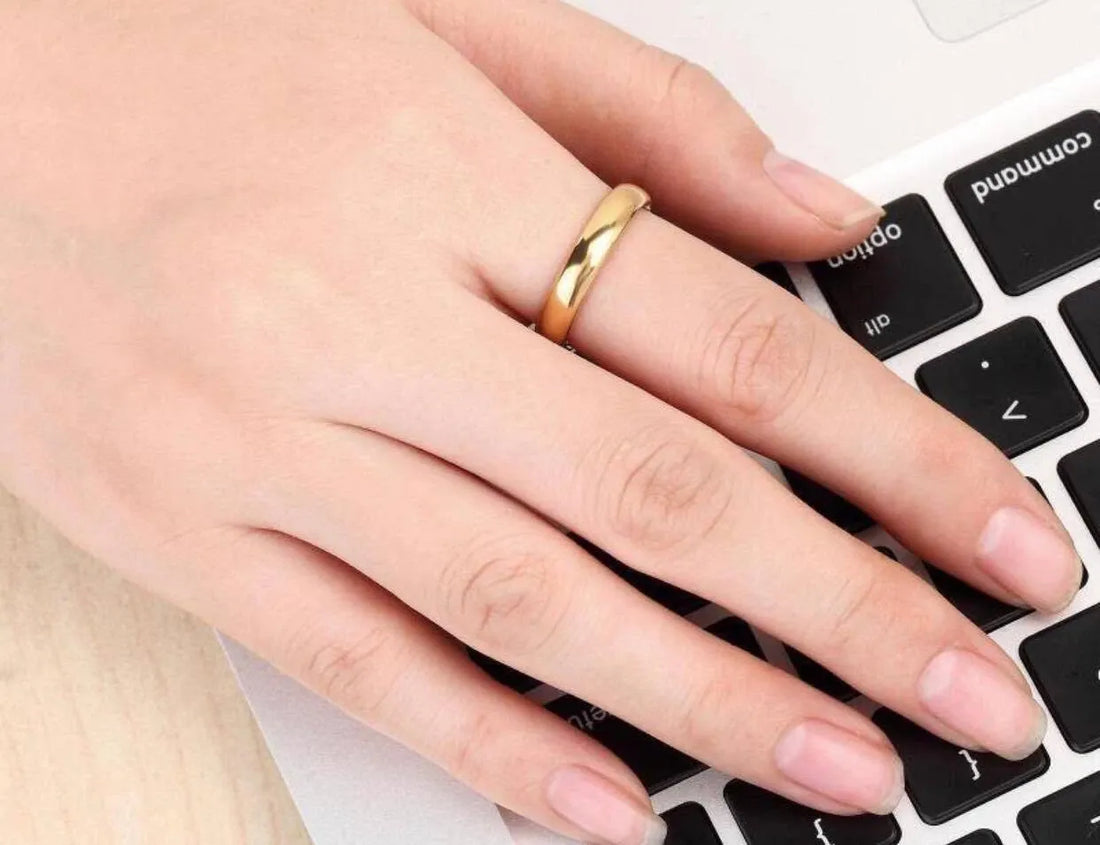 Gold ring on a light gray background