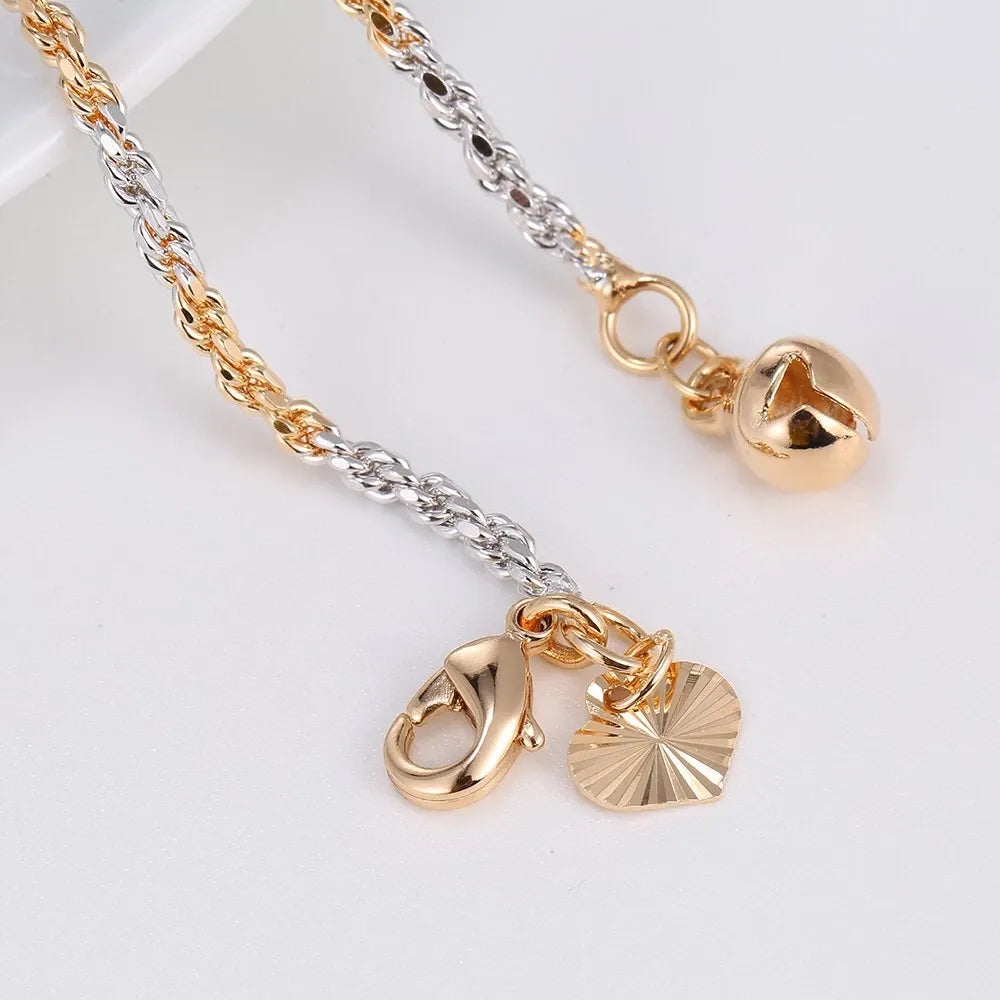Gold and silver necklace with heart-shaped pendants on a white background