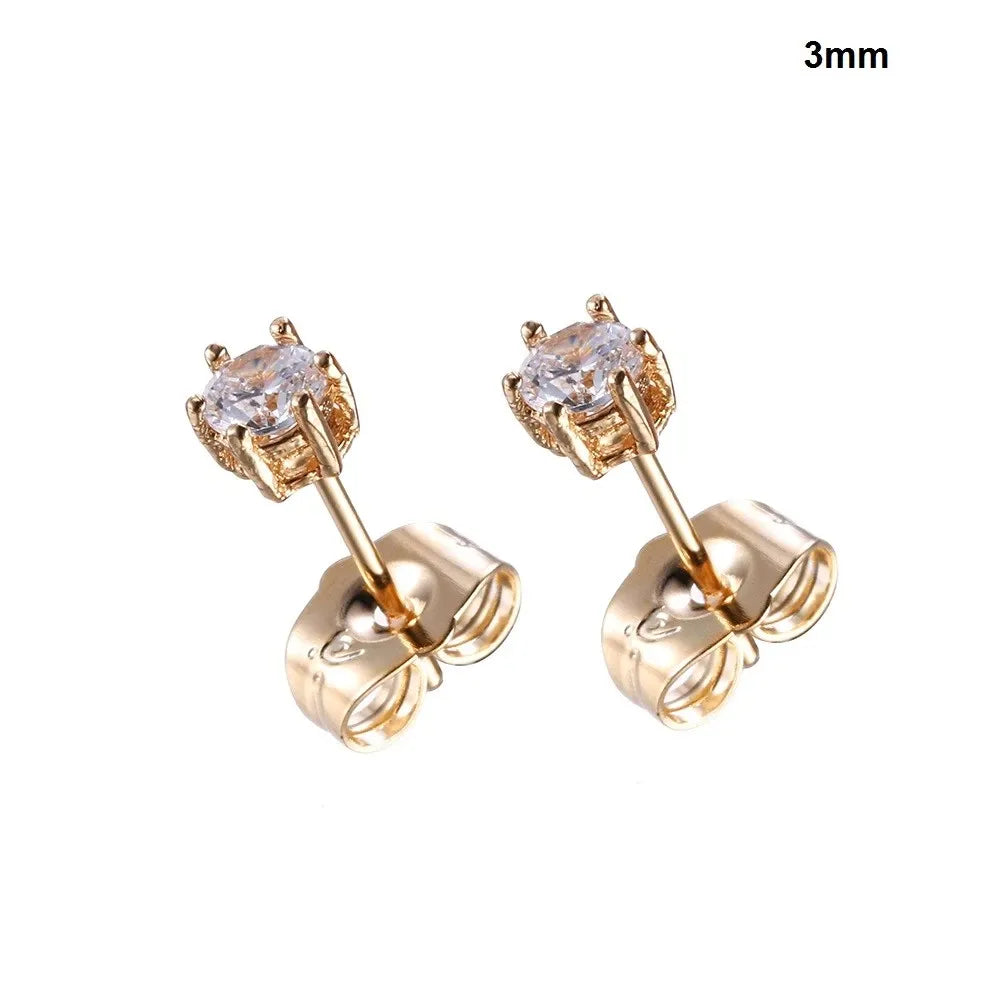 Gold stud earrings with clear gemstones on a white background
