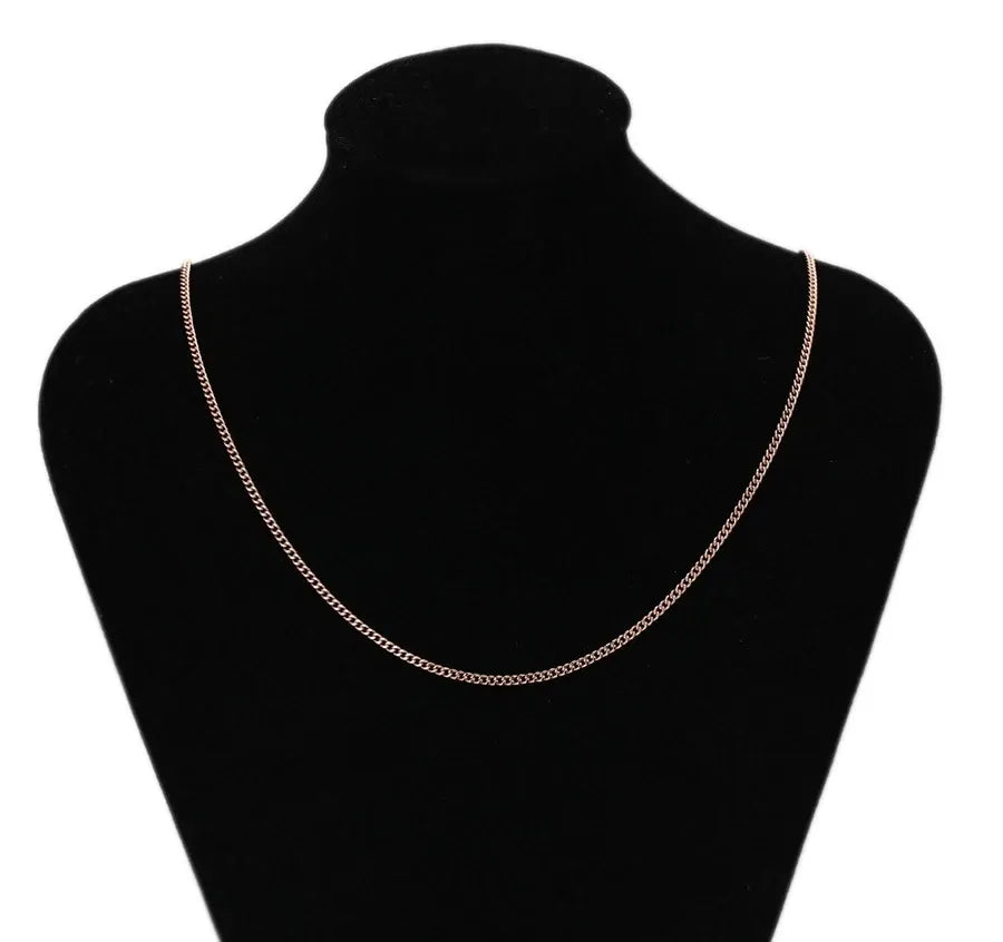 Necklace on a black mannequin bust with a white background