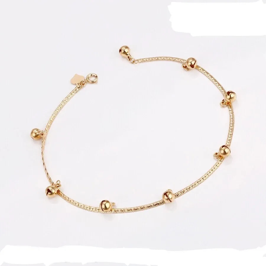 Gold  Anklet with small beads on a white background