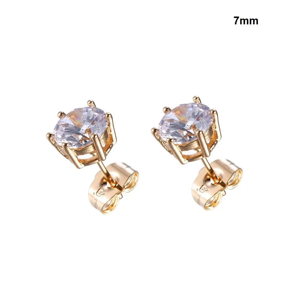 Gold earrings with clear gemstones on a white background