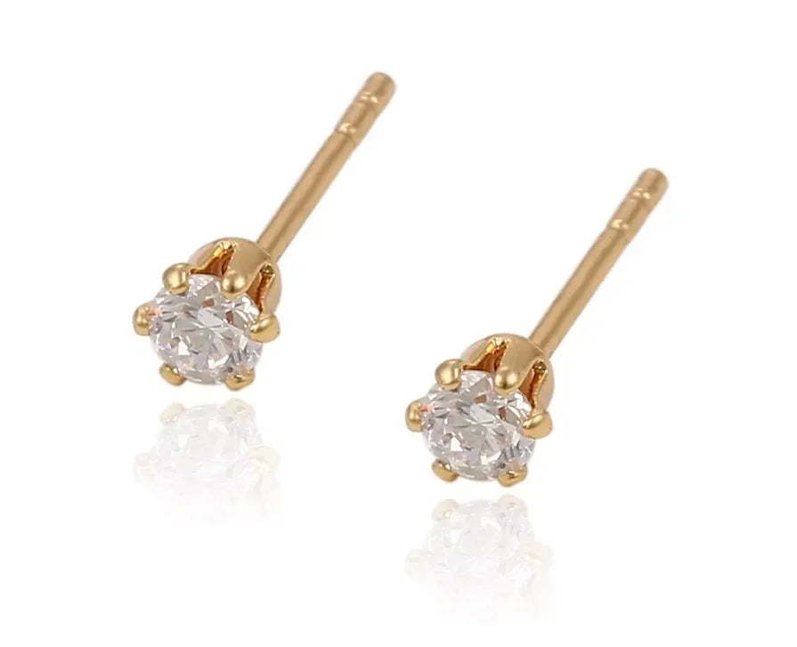 Gold stud earrings with clear gemstones on a white background