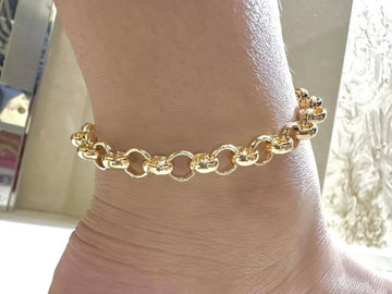 Gold chain anklet   with a blurred background