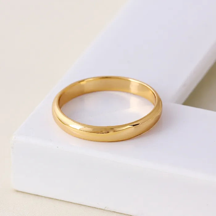 Gold ring on a white surface
