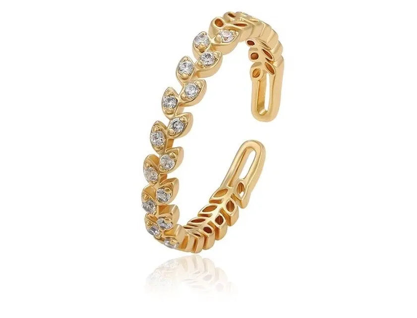 Gold earring with diamond-like stones on a white background