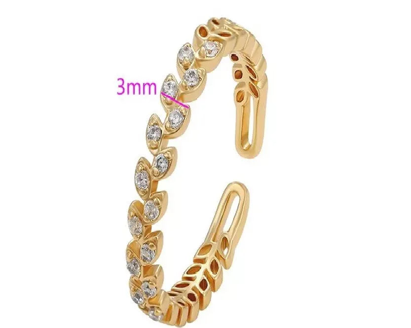 Gold earring with clear stones on a white background