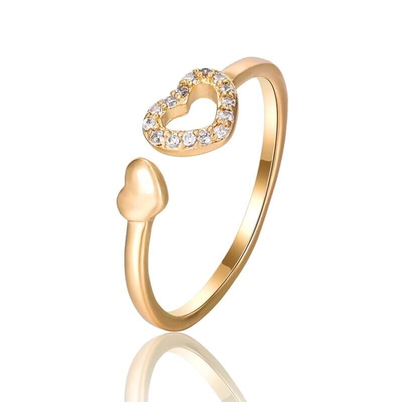 Gold heart-shaped ring with clear stones on a white background