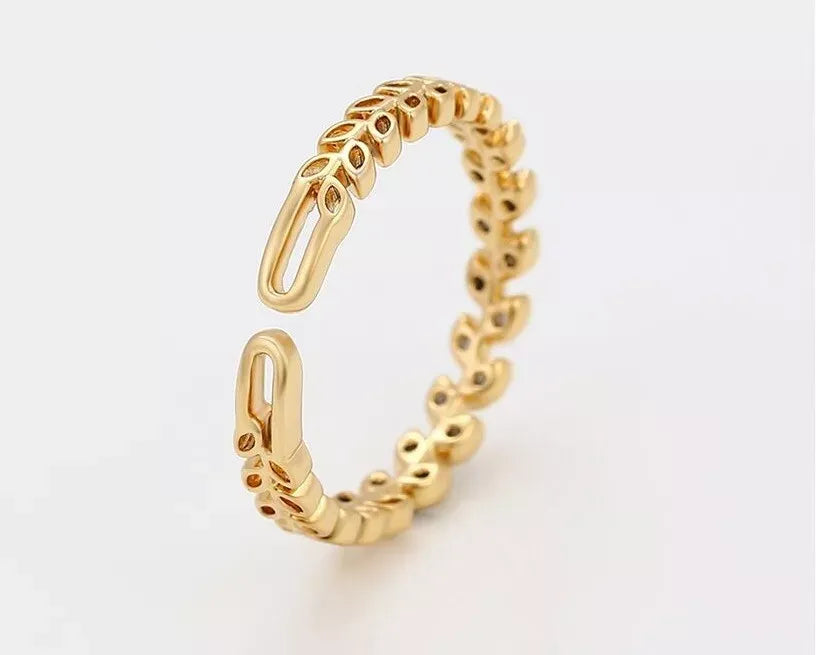 Gold ring with a unique design on a light gray background
