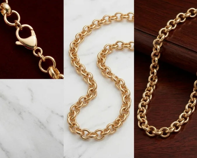 Gold chain necklace displayed on a marble surface with close-up details.