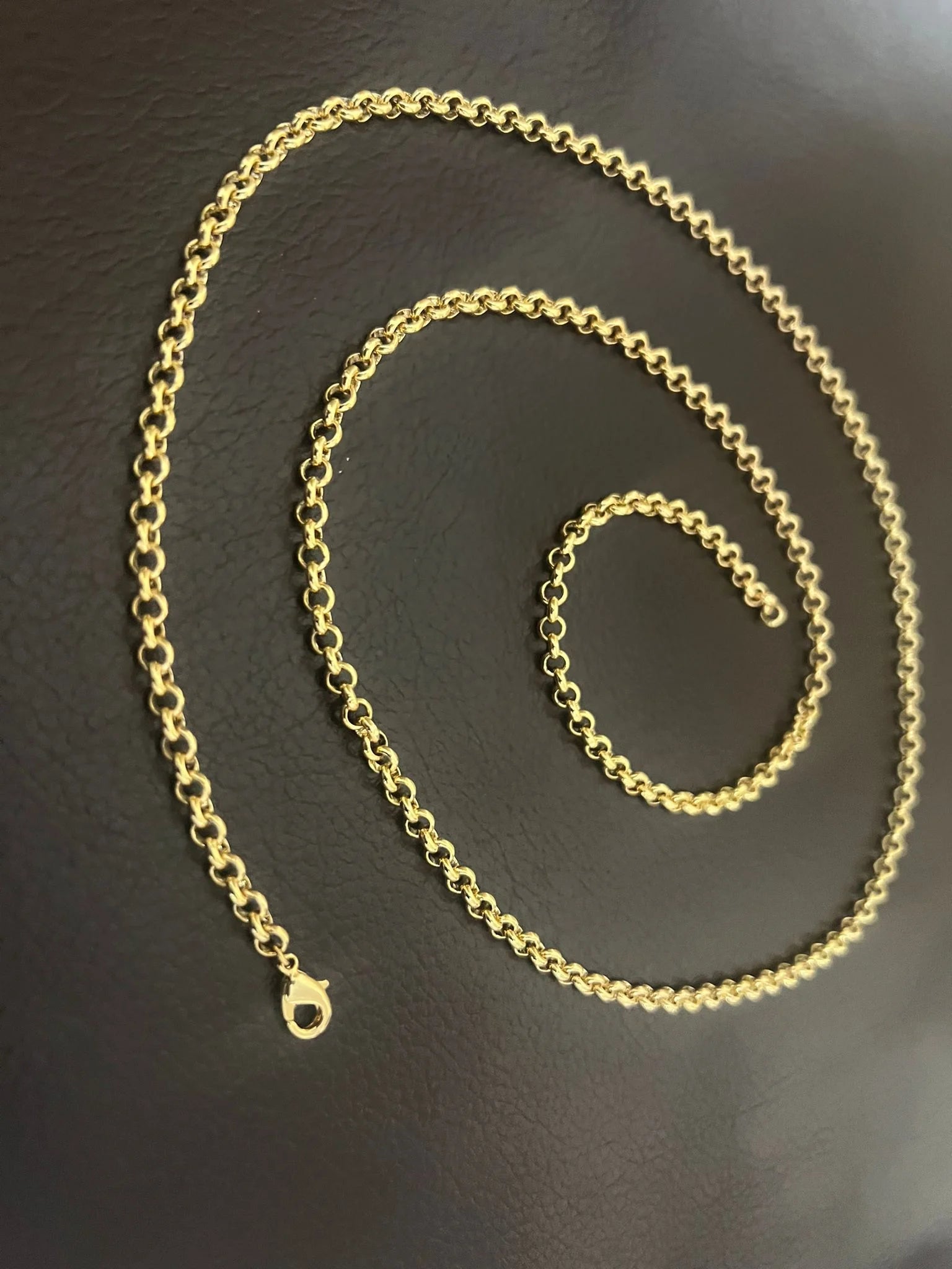 Gold chain on a dark surface