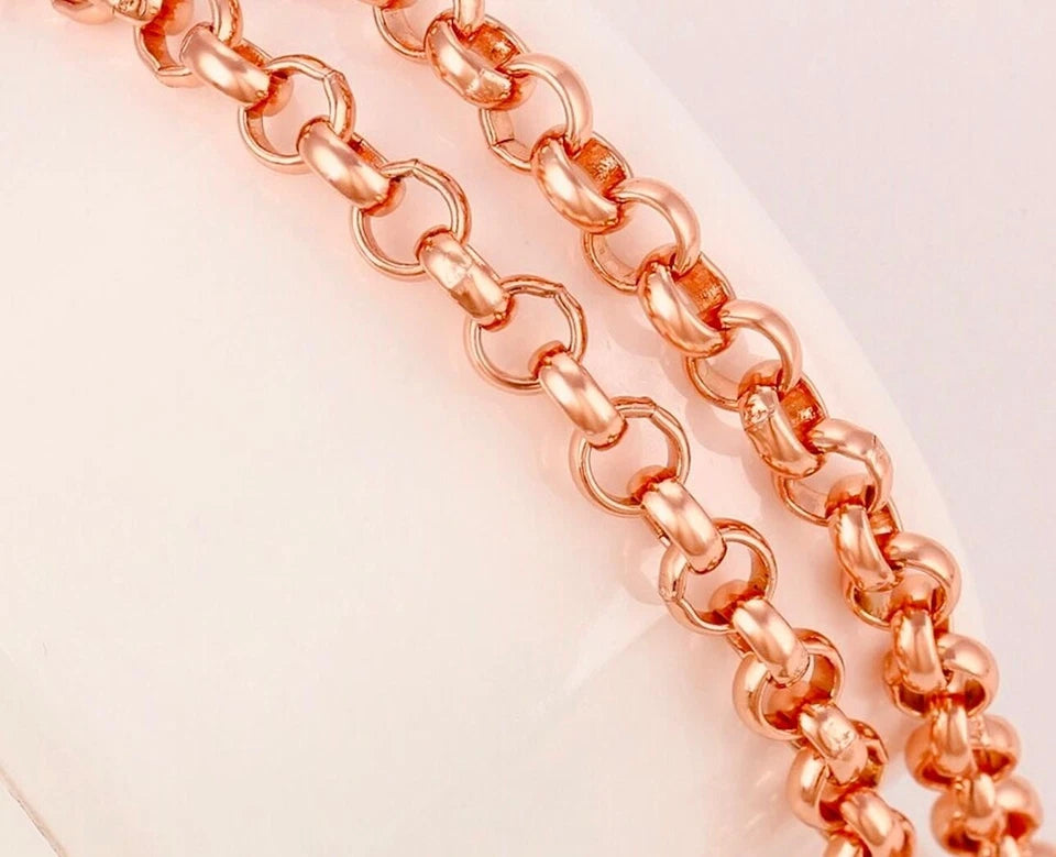Rose gold chain on a light pink background
